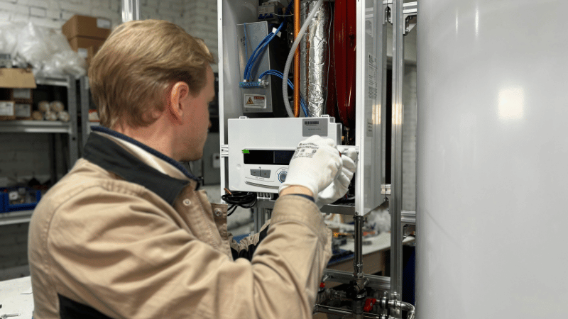 HVAC technician adjusting control components while repairing a residential heating system to ensure safe and efficient operation.