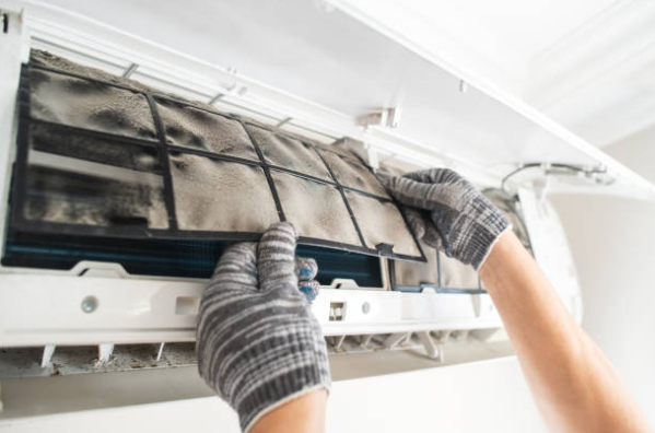 Technician Removing Dirty Mini Split Air Conditioner Filter