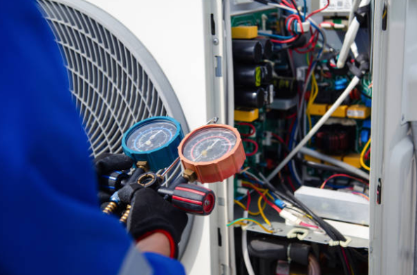 HVAC Technician Checking Refrigerant Pressure With Manifold Gauges