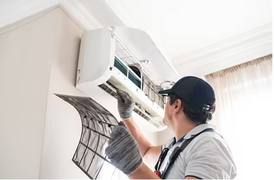 An HVAC technician Checking Indoor AC by taking out Filter