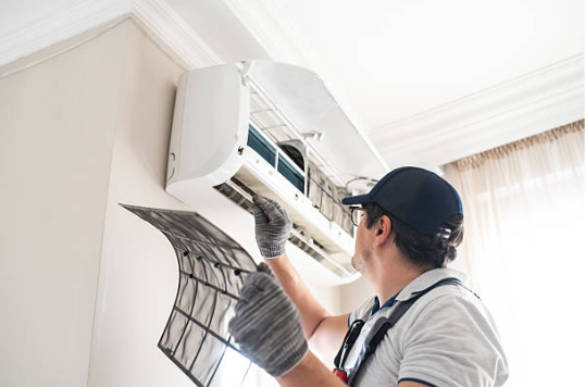 An HVAC technician Checking Indoor AC by taking out Filter